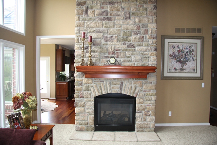 Brick fireplace with wooden mantel