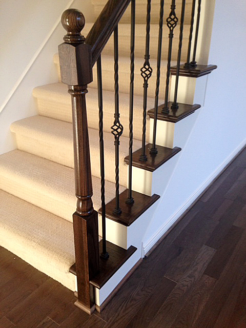 Carpeted staircase with oak end caps