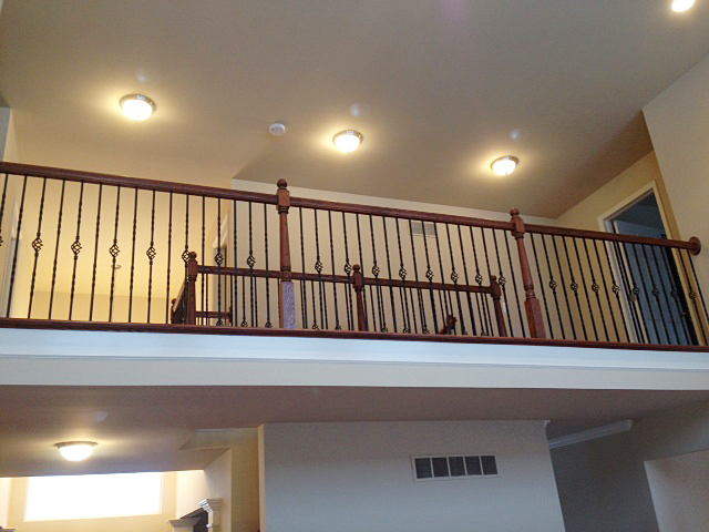 Catwalk with railing featuring rod iron basket spindles