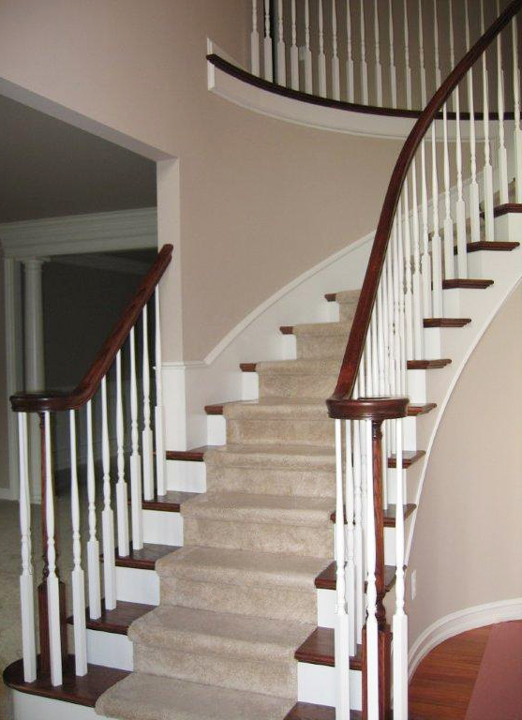 Curved Staircase with painted spindles and vuelet