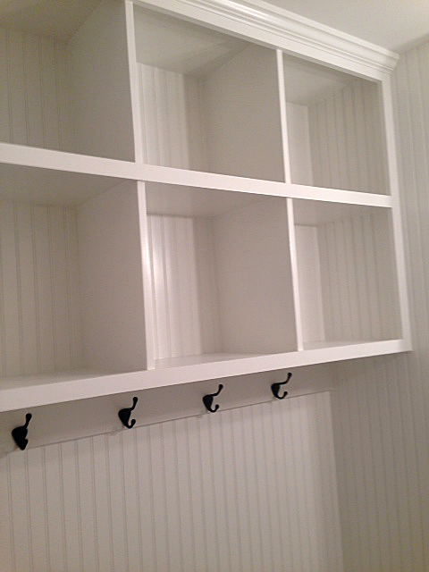 Custom built in shelves with wainscoting paneling