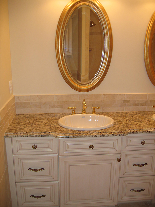 Dual vanity with tile backsplash, granite counter tops and painted cabinets