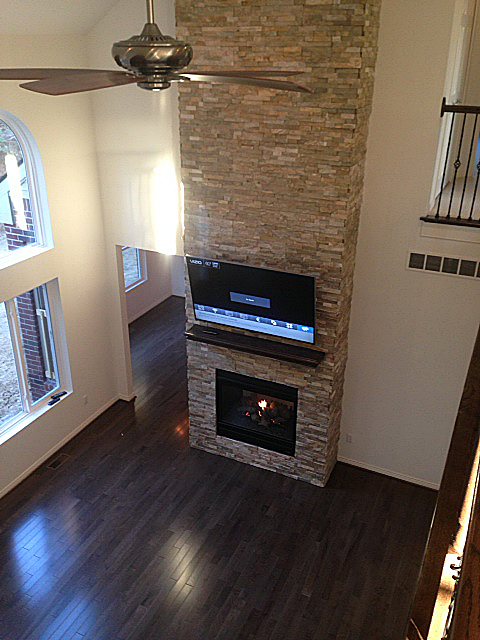 Fireplace built into stacked ledge rock from floor to ceiling
