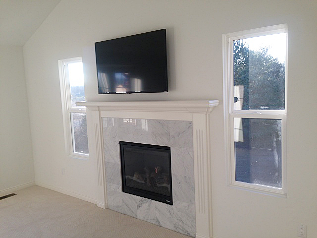 Fireplace with tv hung above the white painted mantle