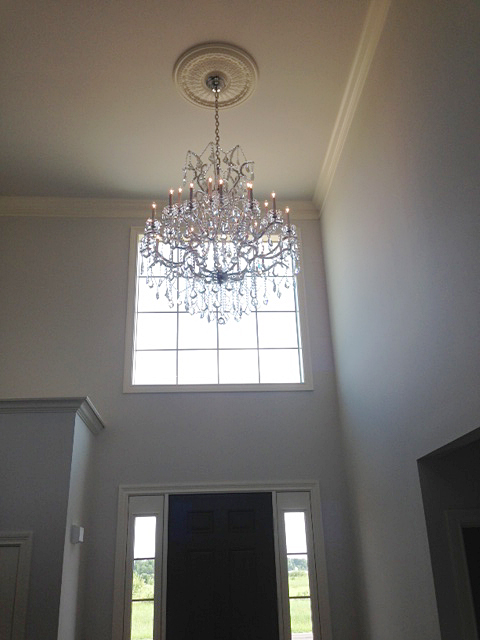 Foyer with open ceilings and chandelier