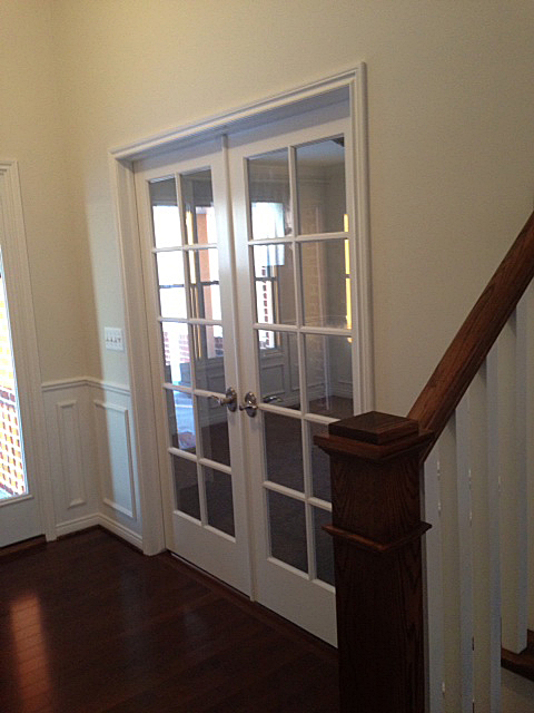 Foyer with ten light double doors entrance into next room