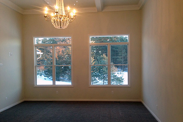 Great room with crown molding and seven light chandelier