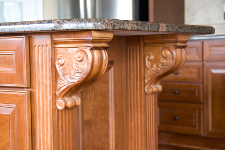 Kitchen island with corbels supporting granite overhang