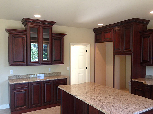 Kitchen with cabinetry featuring crown molding at top