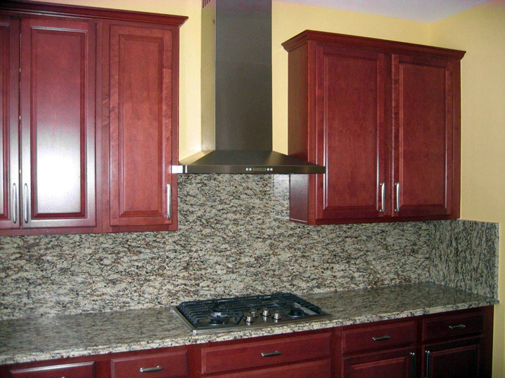 Kitchen with granite counter tops and granite backsplash