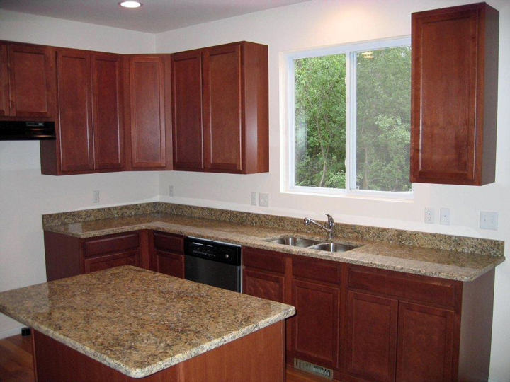 kitchen with granite counter tops and island featuring snack bar