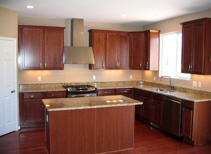 Kitchen with granite counter tops, cherry finish cabinets, and island with snack bar
