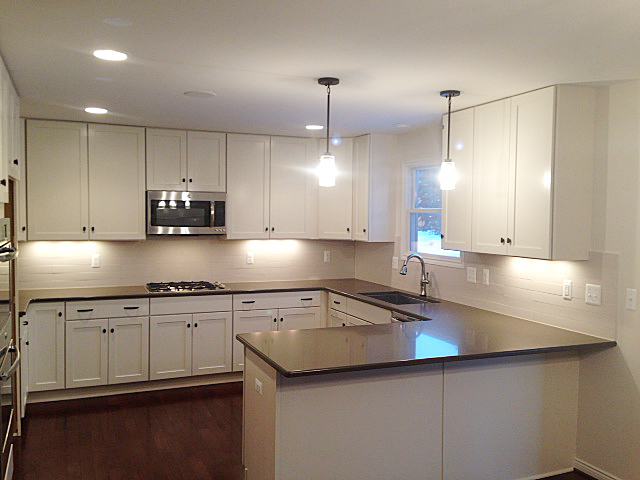 Kitchen with quartz counter tops and white painted shaker cupboards