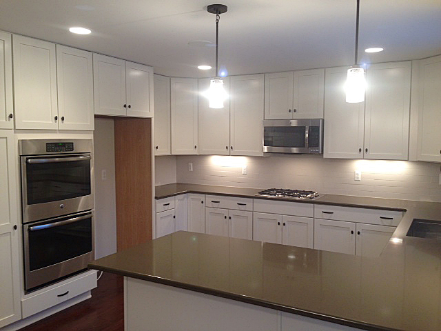 Kitchen with white painted shaker cabinets and quartz counter tops