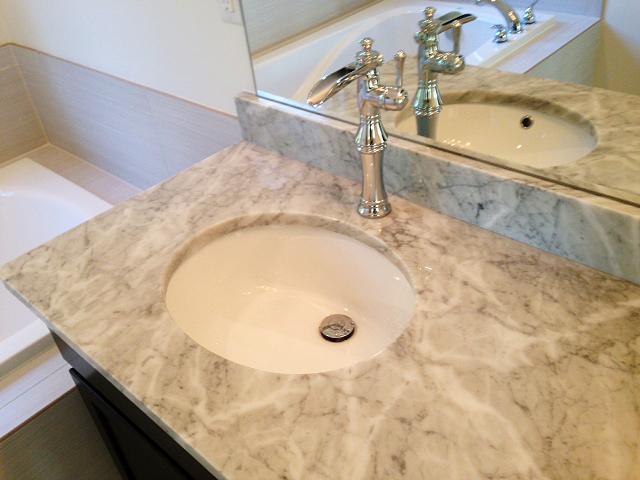 Marble counter top with under mount sink and waterfall faucet