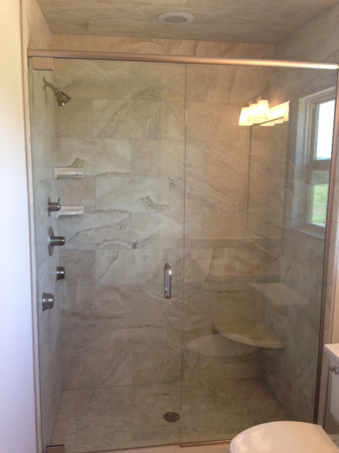 Master bath shower with Euro doors, marble bench, and body sprayers