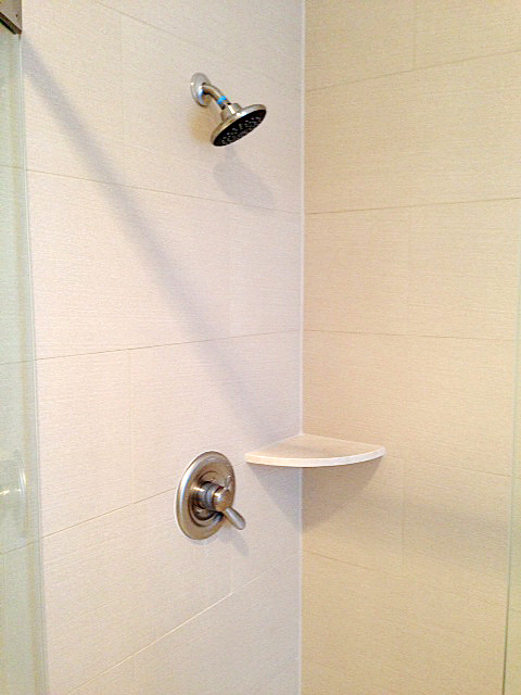 Shower featuring brick stacked tile