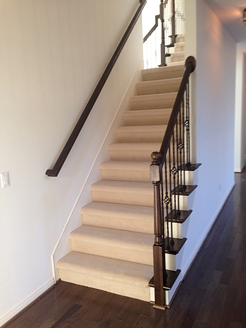Split staircase with carpeted with wooden end caps