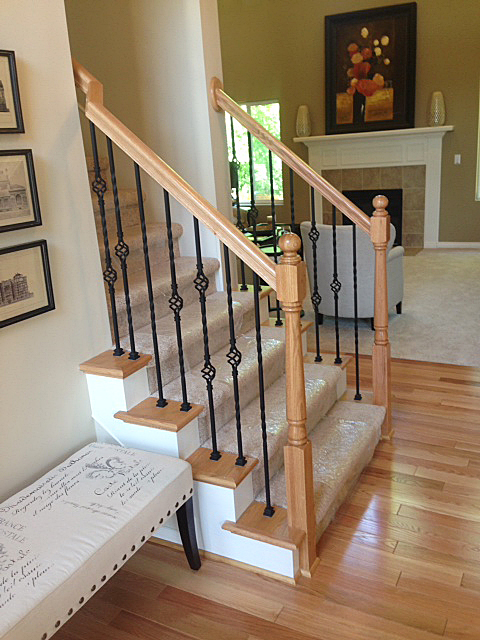 Staircase featuring rod iron basket spindles in diamond pattern
