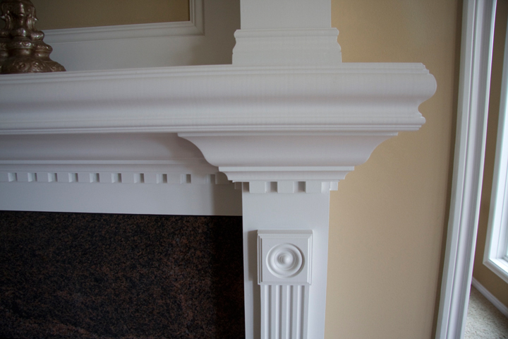 White painted mantel with decorative molding