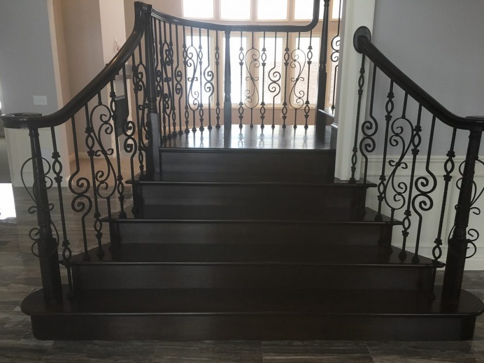 Full wood staircase with decorative rod iron spindles