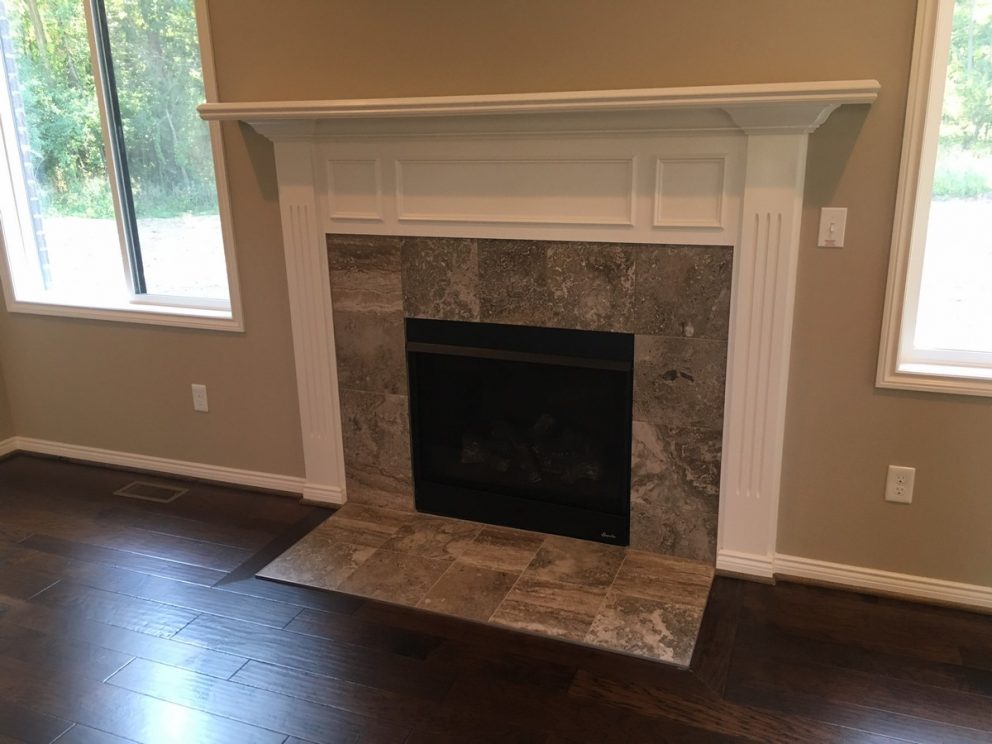 Great room fireplace with tile border and decorative mantel