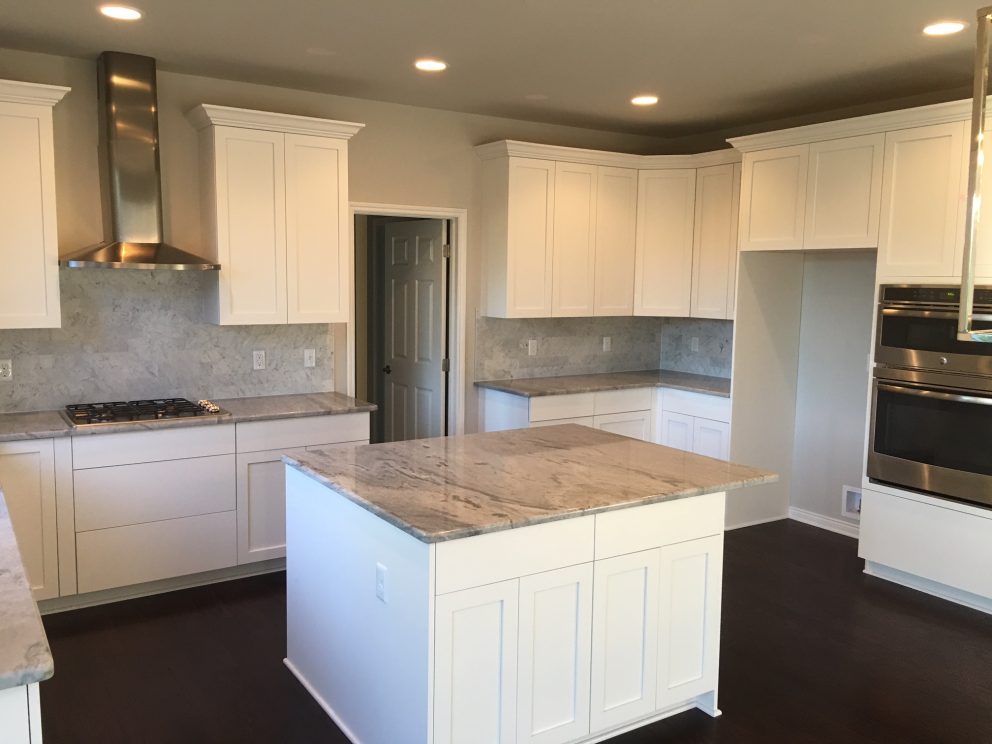 Kitchen with white painted cabinets and shaker doors