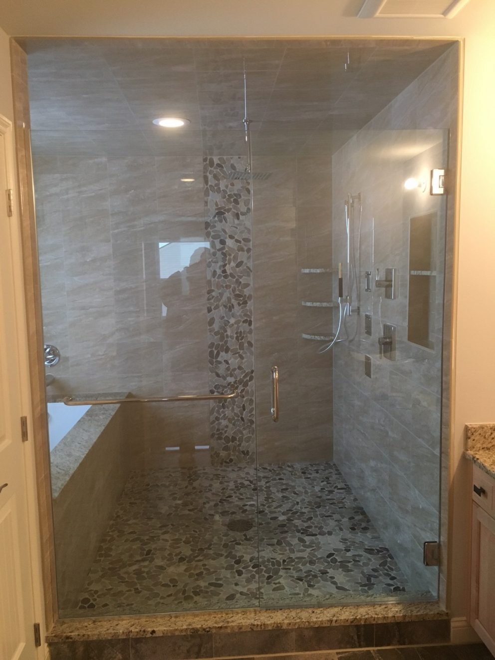 Master bath shower featuring body sprayers, rainhead and pebble floor