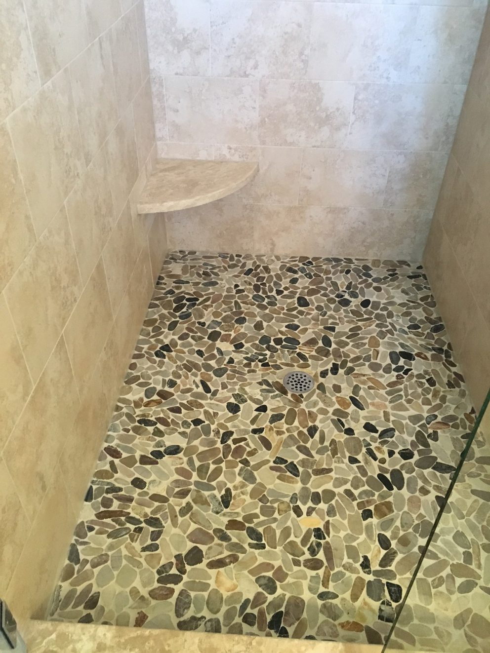 Master bath shower with custom stone floor