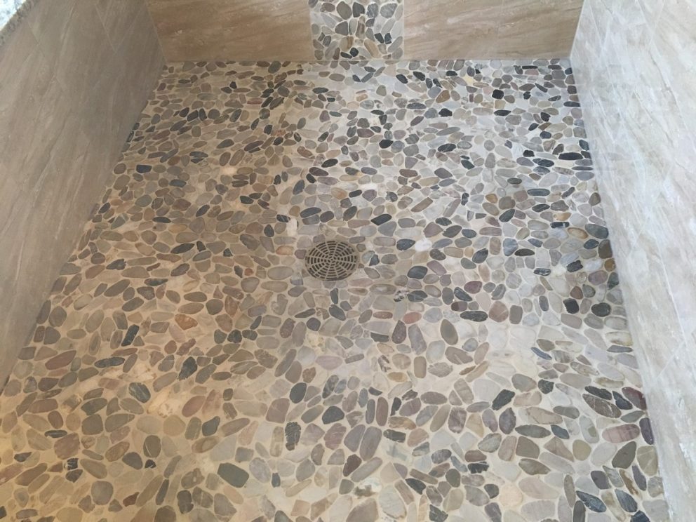 Master bath shower with custom stone tile floor