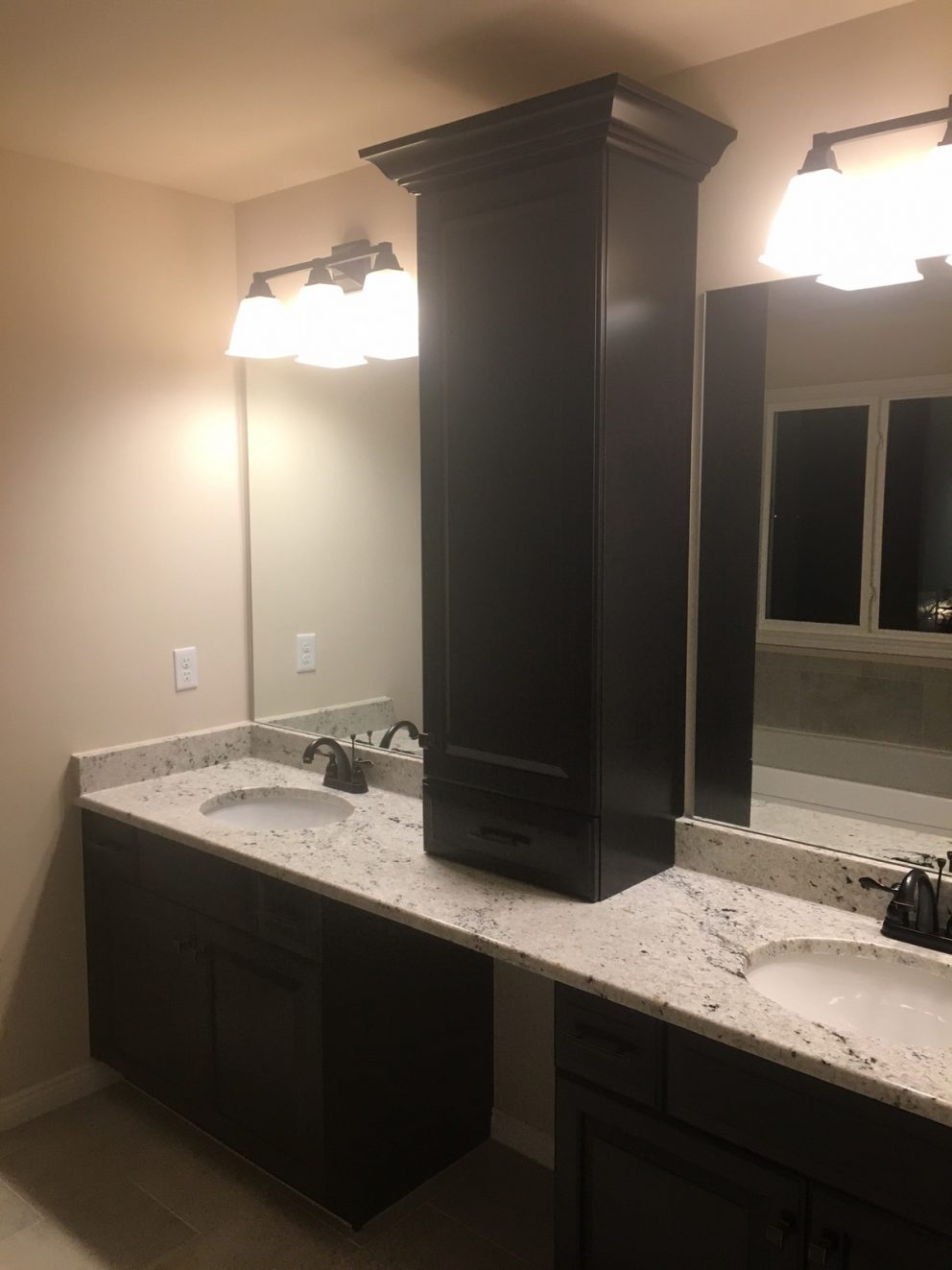 Master bath with his and her sinks and tower cabinet
