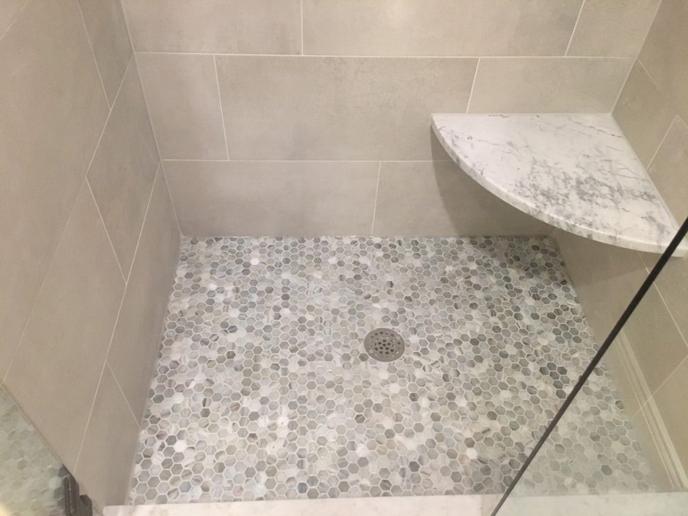 Shower with hexagon mosaic tile floor