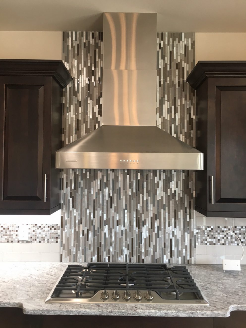 Tile backsplash with stainless steel hood vent